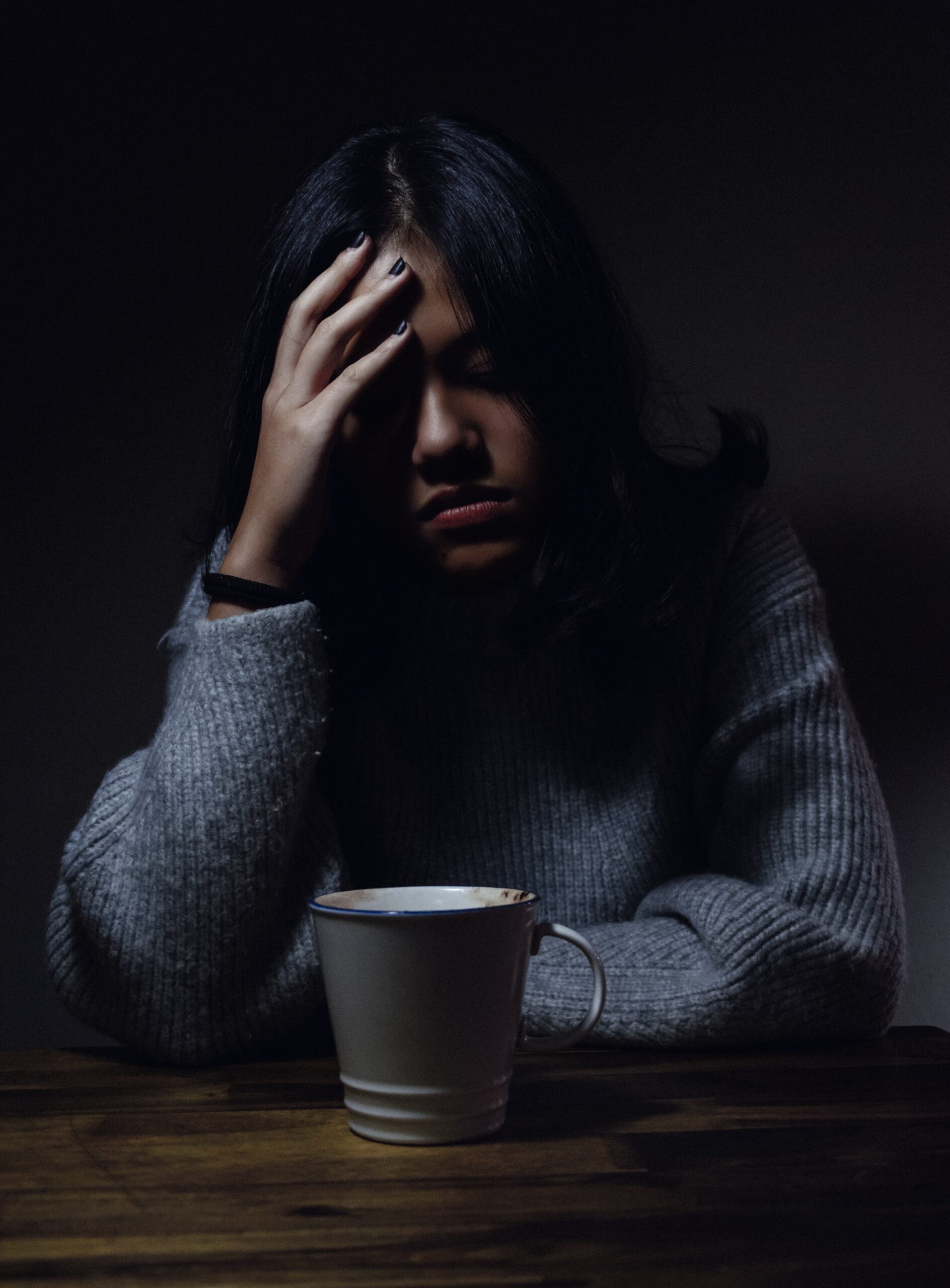 Photo by Anh Nguyen woman in gray sweater seating on chair
